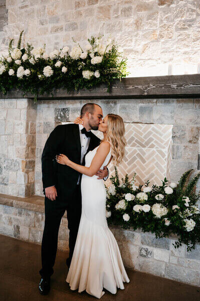 Bride and groom kissing at wedding by wedding planners in chicago