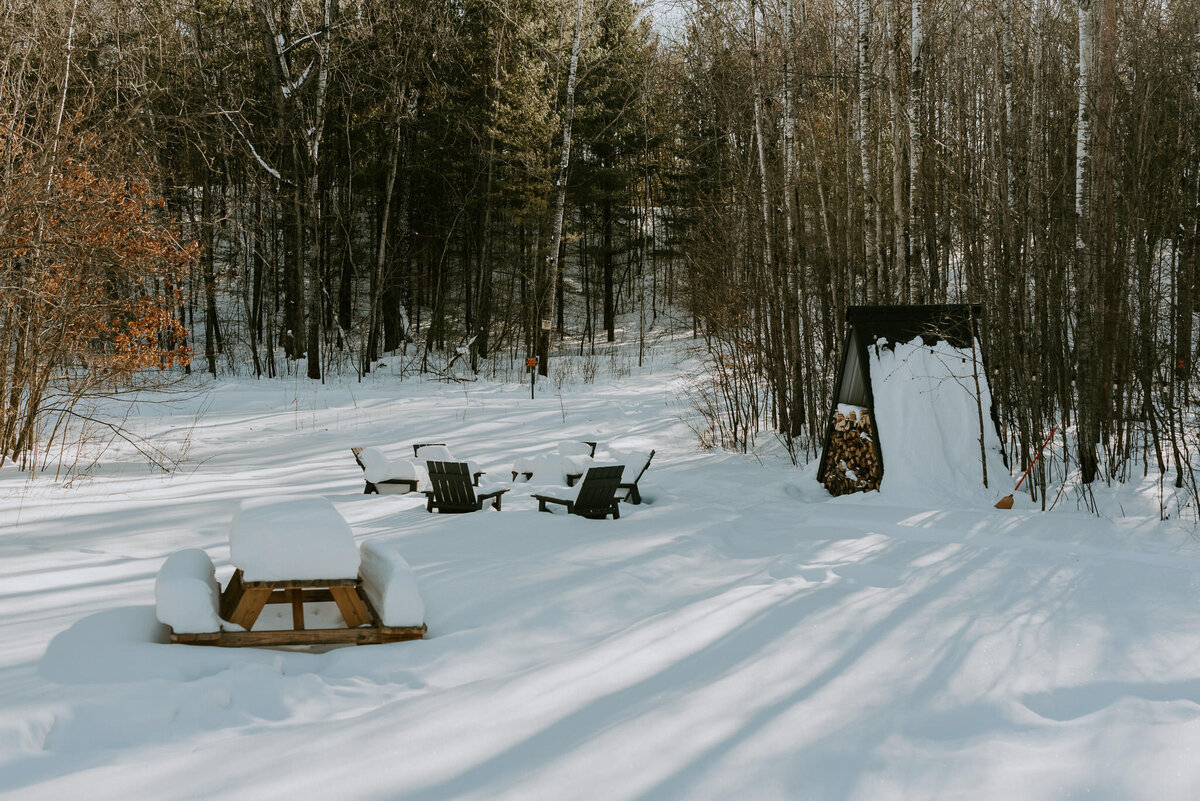 Picnic and fire pit area outside of aframe cabin in Northern Minnesota.
