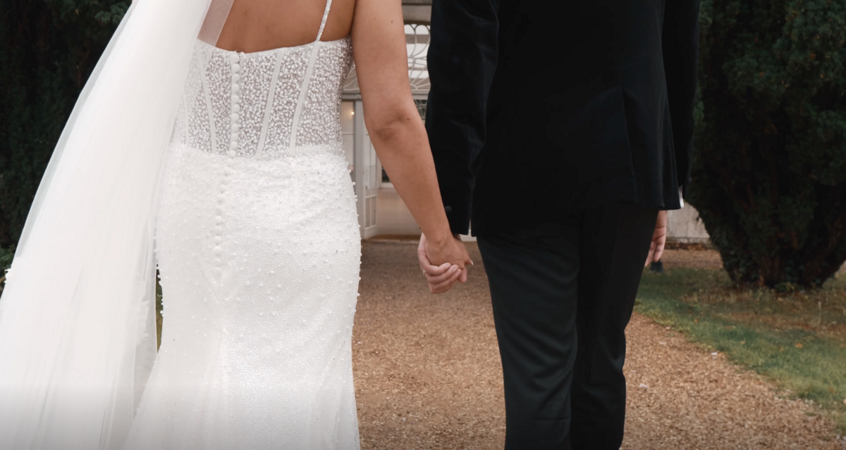Bride and Groom on their wedding day, hand in hand, at Northamptonshire's Barton Hall. Captured on film by Northamptonshire wedding videographer HC Visuals.