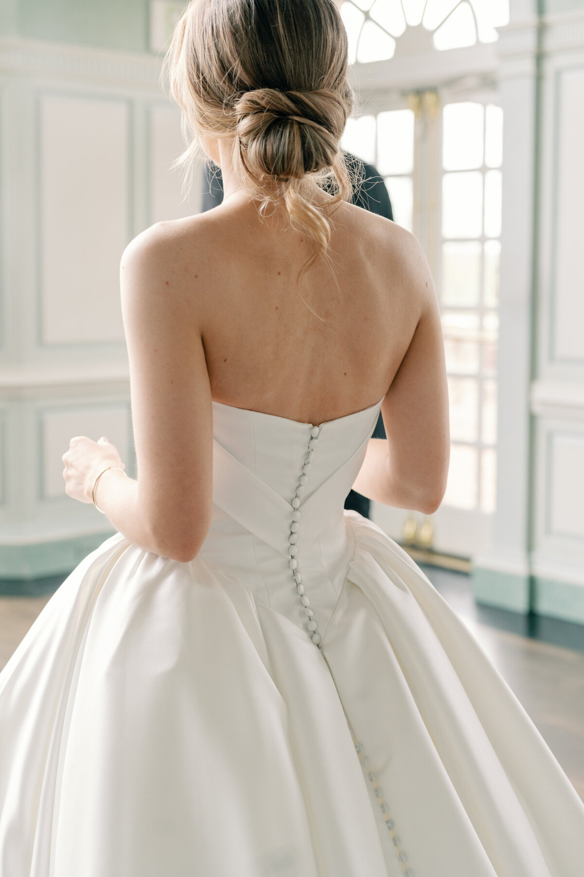 Estate at River Run Wedding in Maidens, VA | Wedding Photographer in Richmond | back of bride's wedding gown as she walks towards her groom in the ballroom of the Estate at River Run