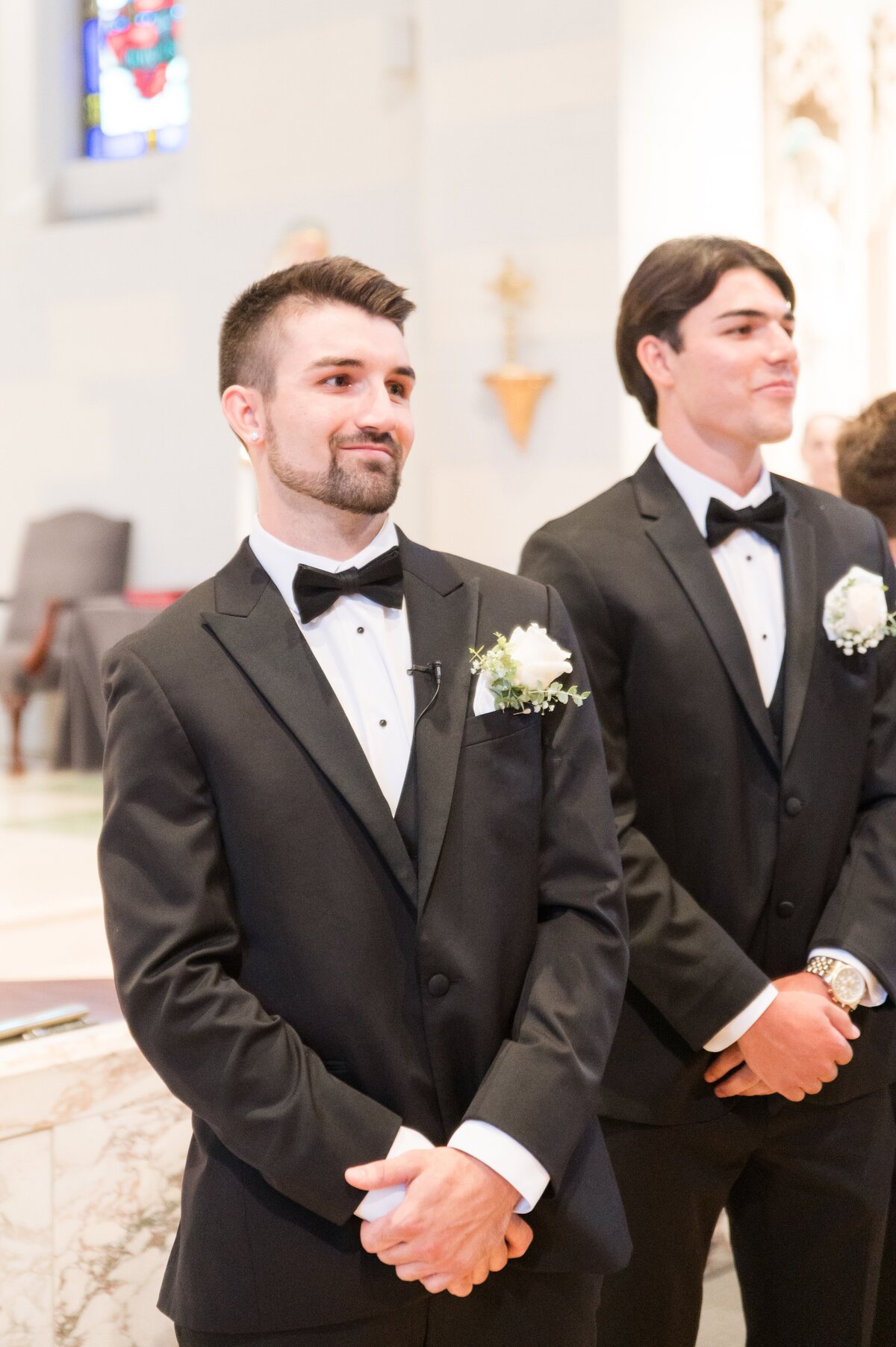 groom excitedly looking at his bride walking down the aisls
