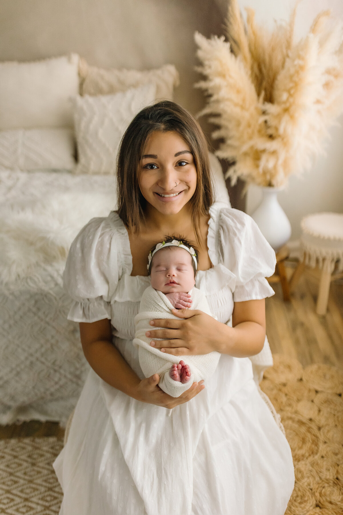 Mom and newborn baby girl in newborn portrait studio