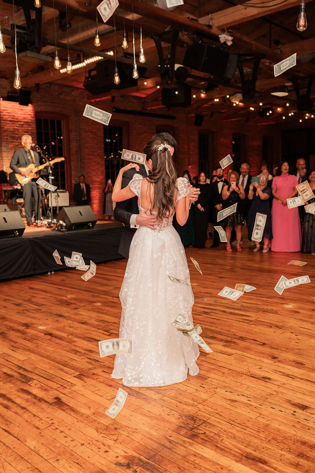 money is tossed for good luck onto couple during first dance