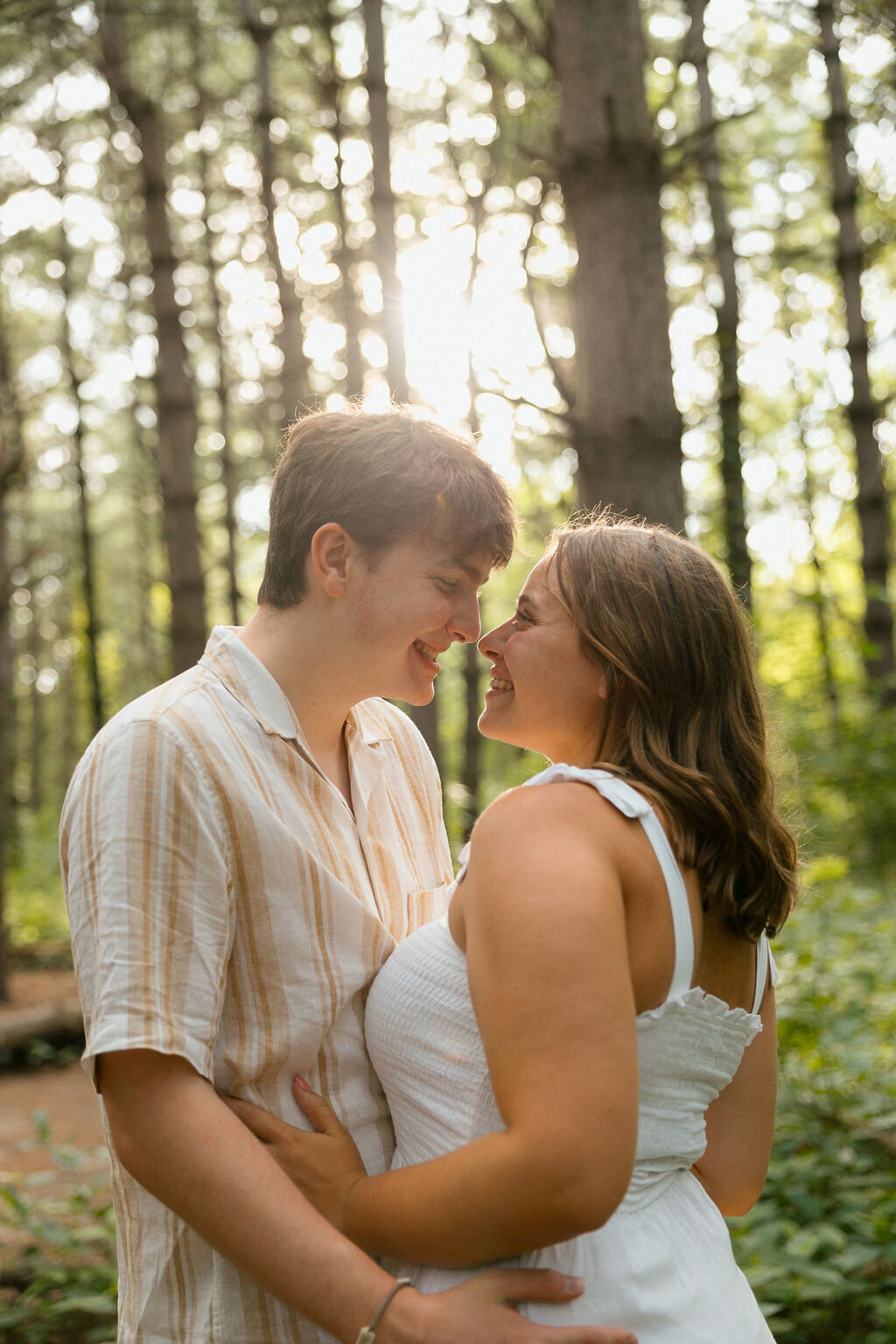 couple embraces during engagement photos in kansas city