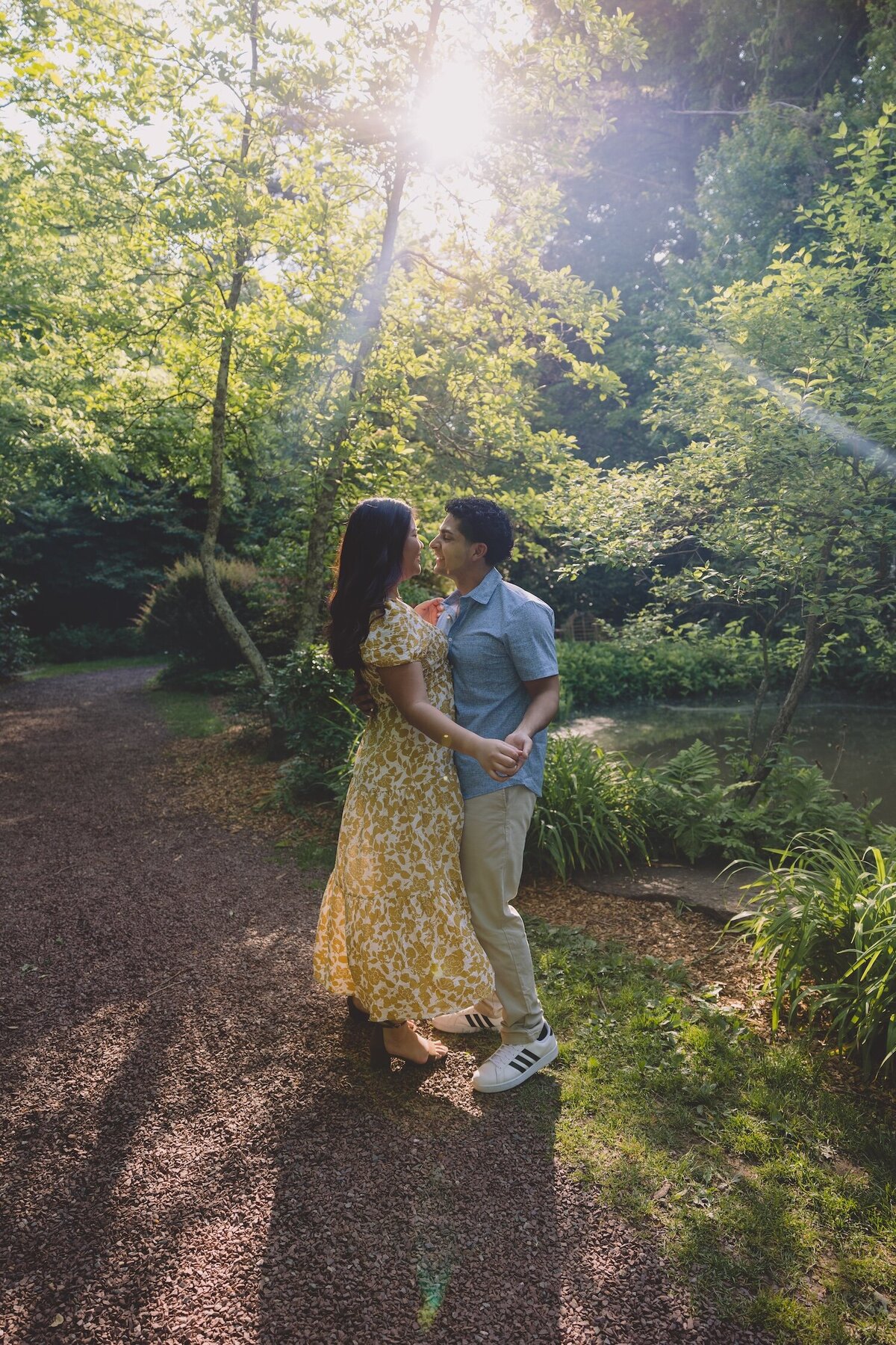 Couple dancing together under a sunlit tree in Sayen Gardens.