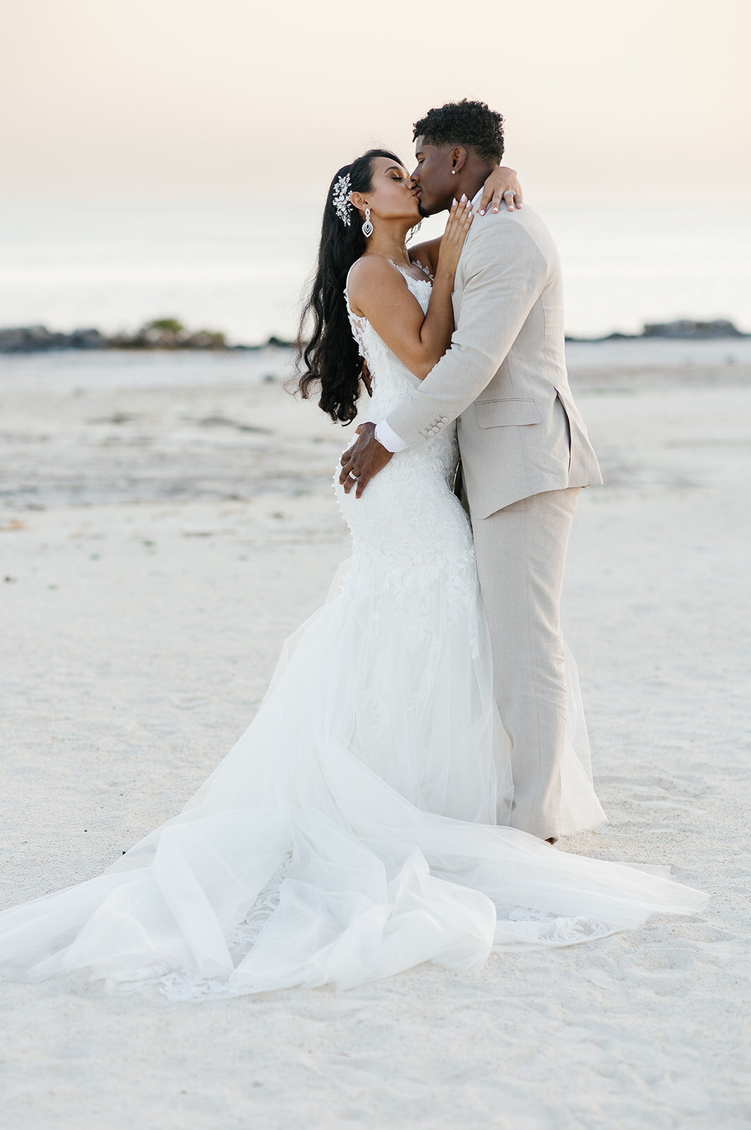Andressa and Jonathan share a passionate kiss along the tide’s edge, framed by the soft hues of a dreamy sunset at Table Key, Islamorada. Photography by Claudia Amalia, Islamorada wedding photographer.