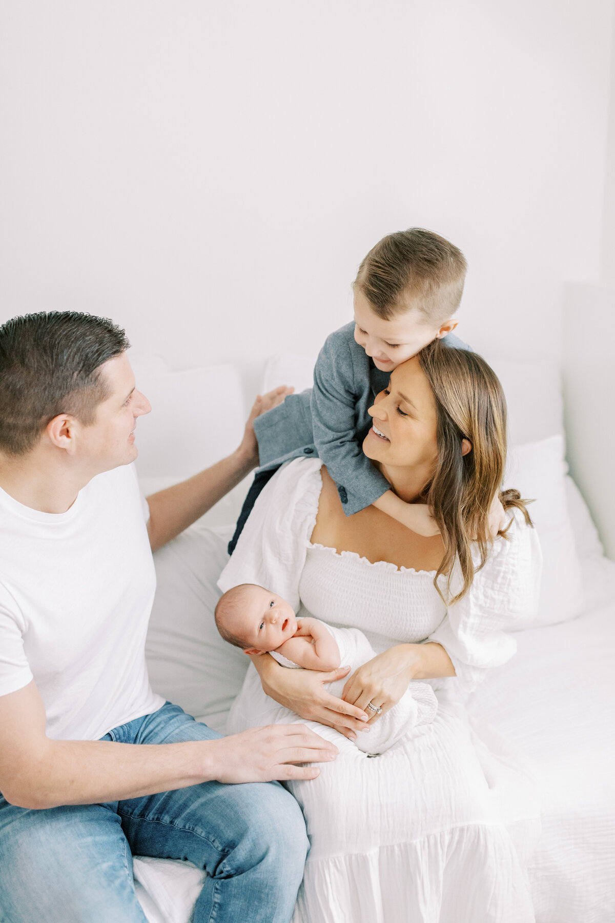 photo of family playing and newborn baby by spokane newborn photographer