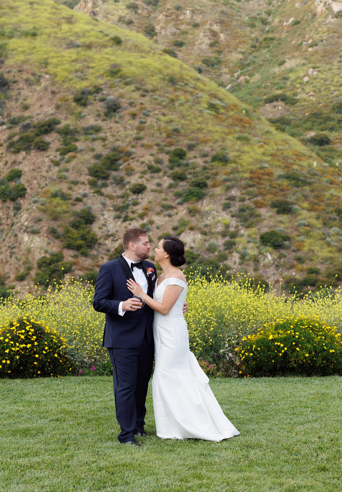 bride and groom taking photos in Malibu