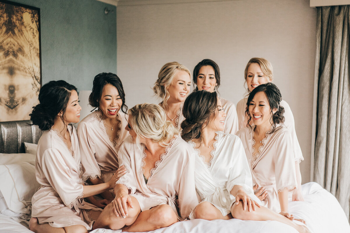 Candid of bridesmaids laughing during getting ready portraits