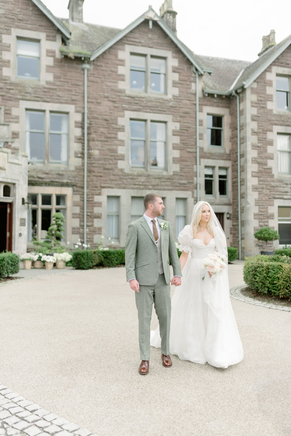 Bride and Groom wandering the grounds of Cromlix House, photographed by Scotland fine art wedding photographer.