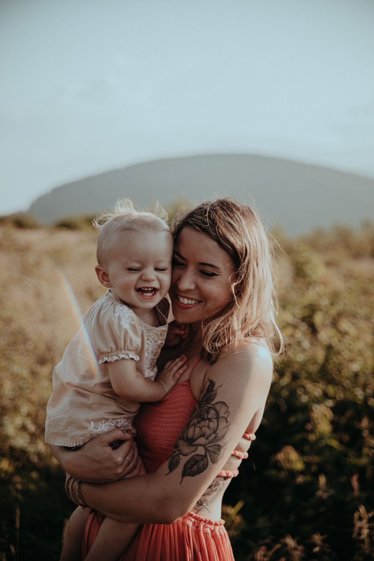 mother and daughter smiling and laughing