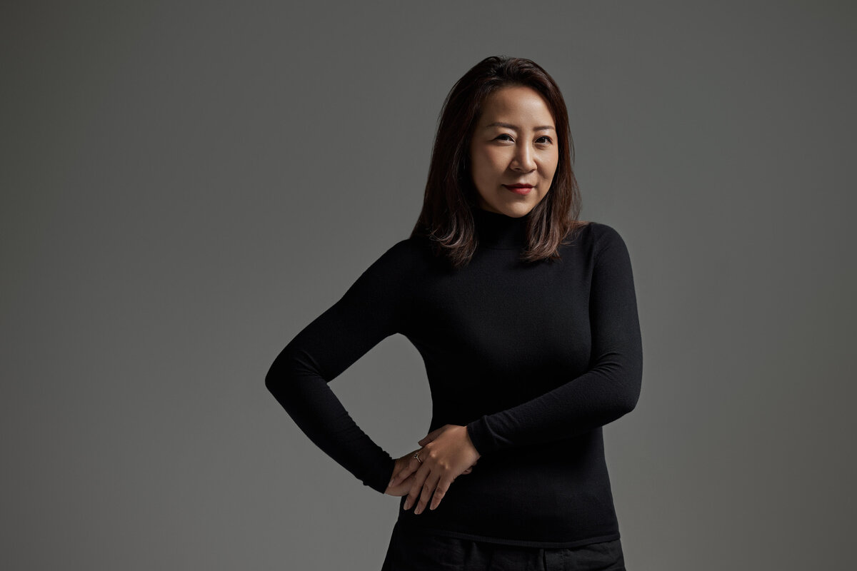A woman with both hands on one hip