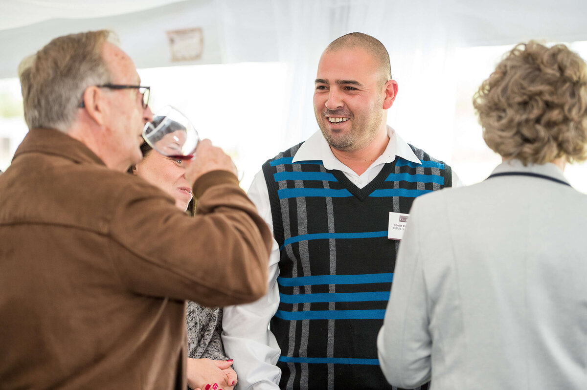 a candid photo of guests mingling at a corporate anniversary celebration.  Captured by Ottawa Event Photographer JEMMAN Photography COMMERCIAL