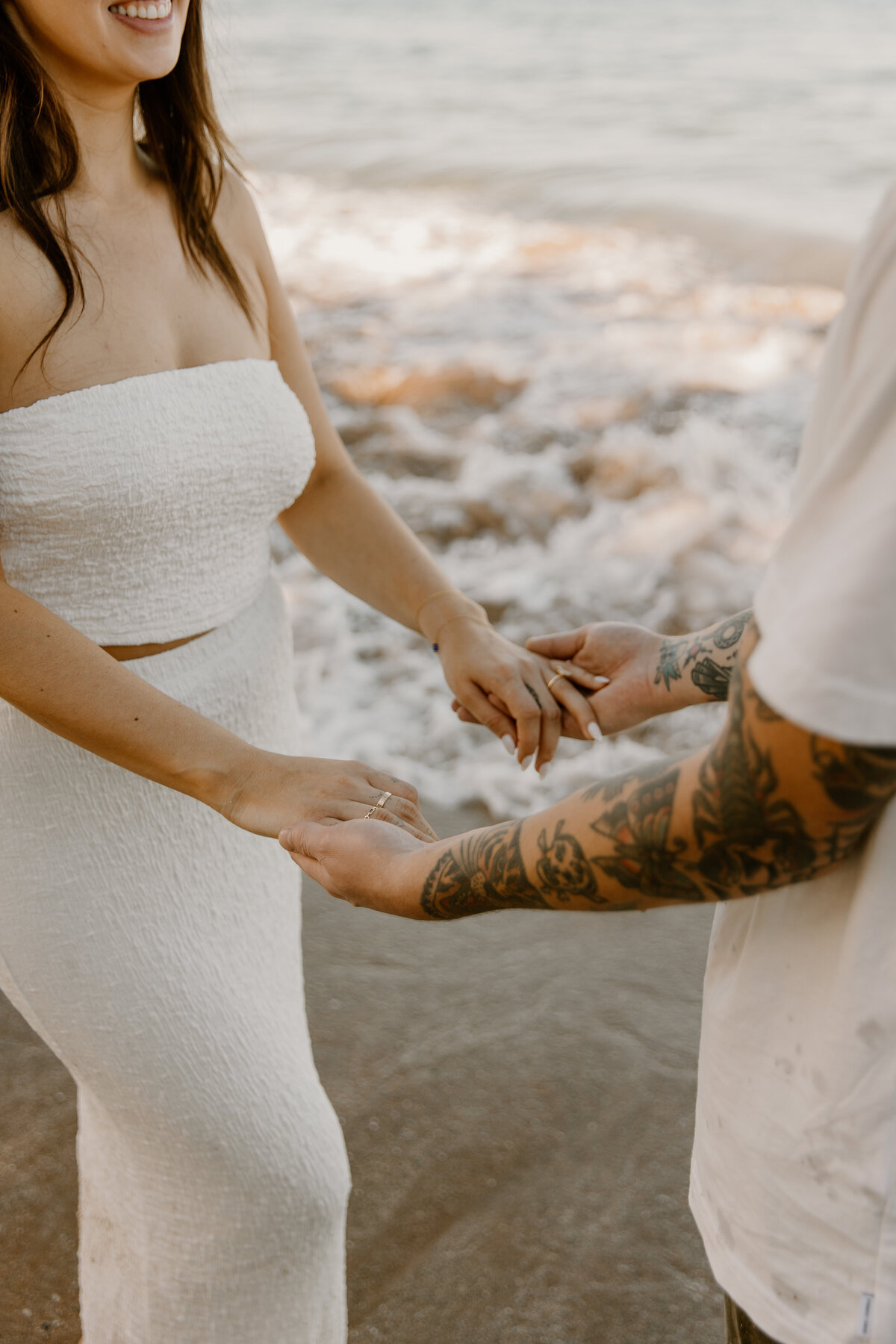 Hawaii Engagement Photographer captures couple holding hands at beach