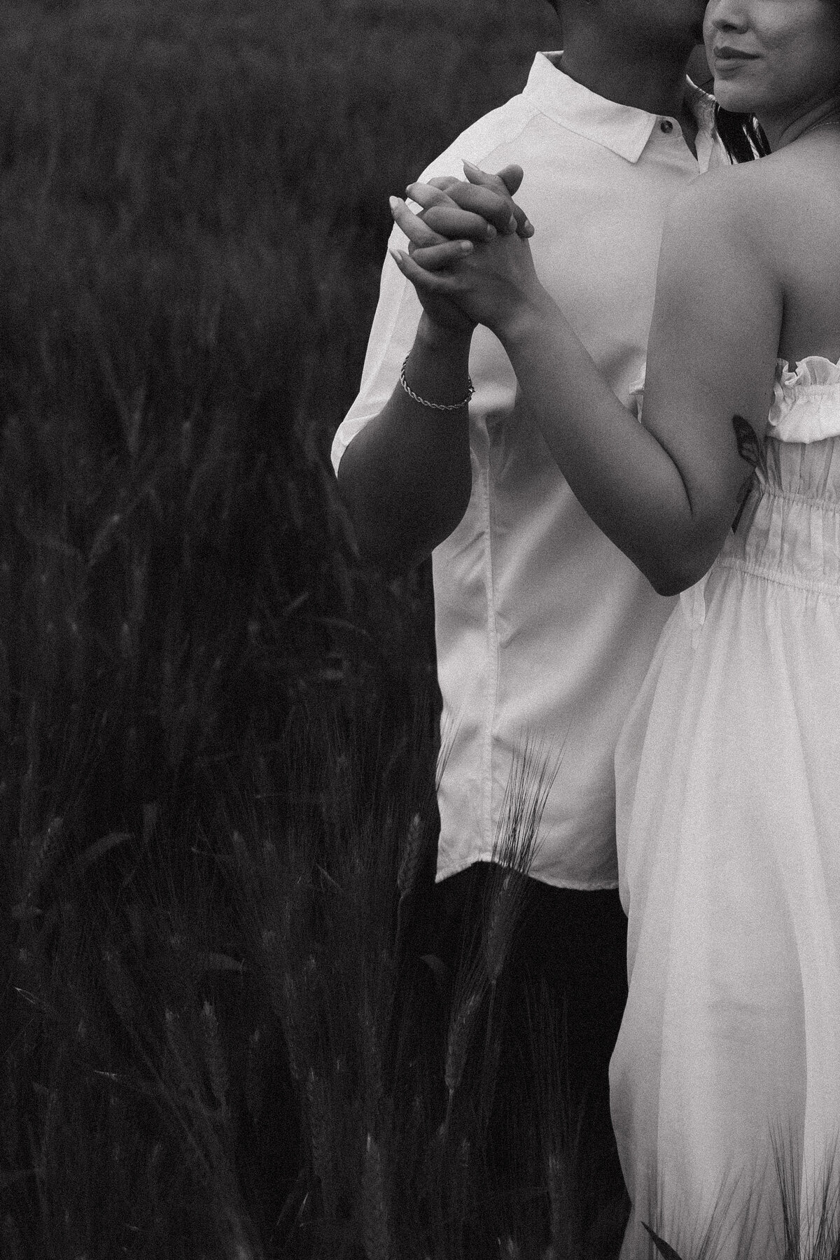 husband and wife holding hands in black and white
