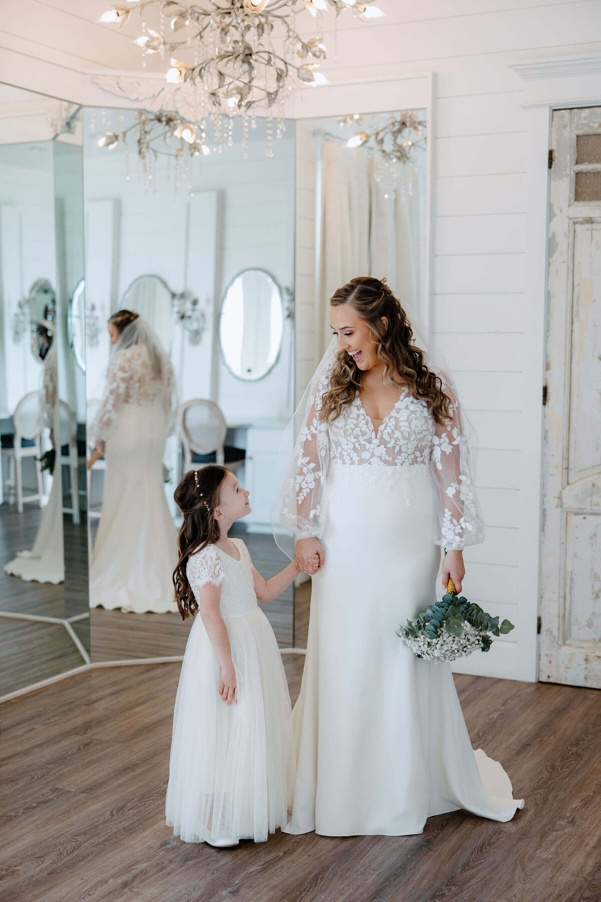 bride and flower girl sharing candid moment before Dallas, Texas wedding ceremony