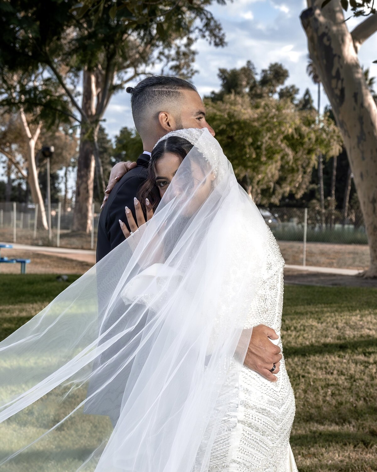 Arabian Wedding Couple Hug Under Flowing Veil – Los Angeles Wedding Photography
