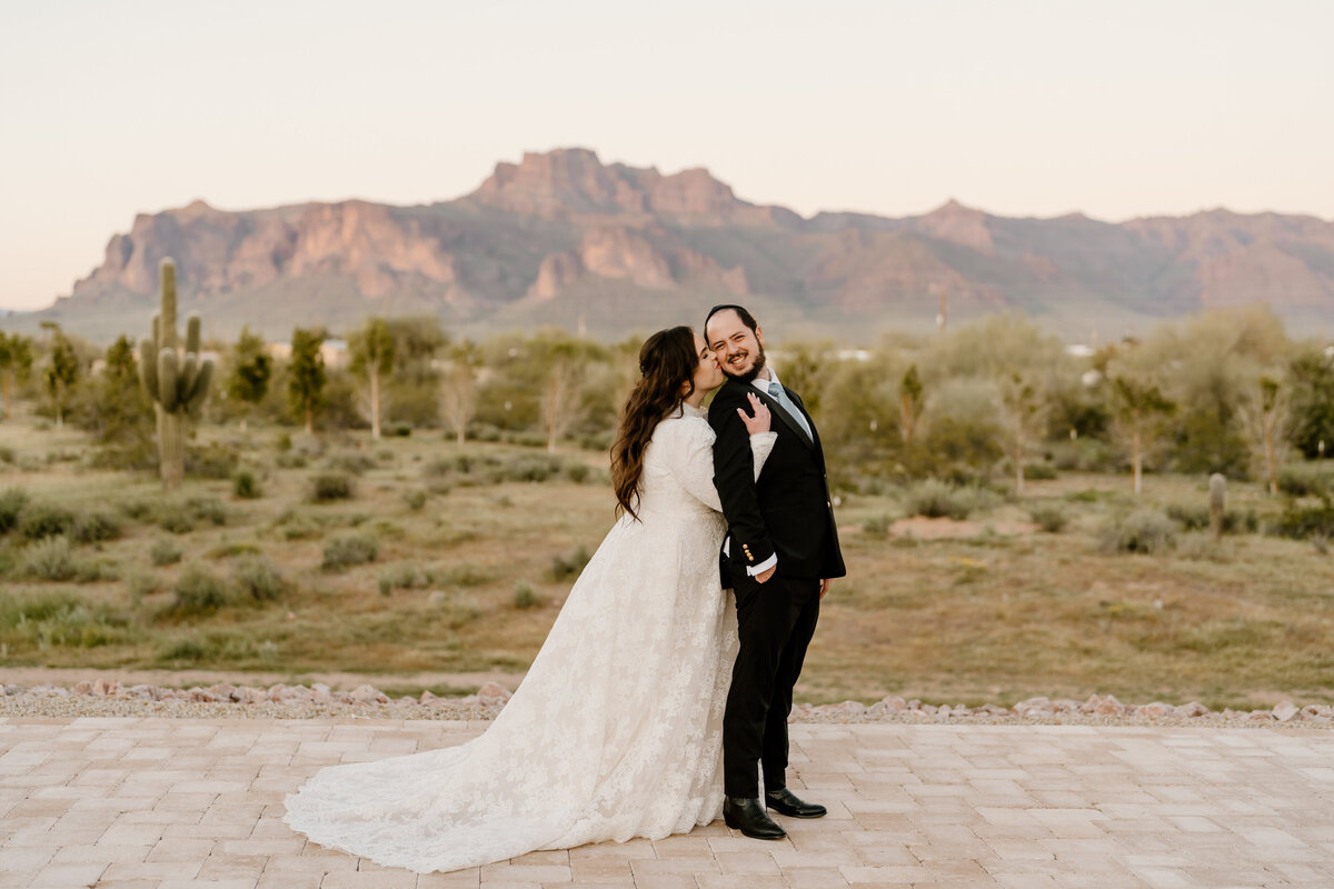 Bride giving groom a hug from behind