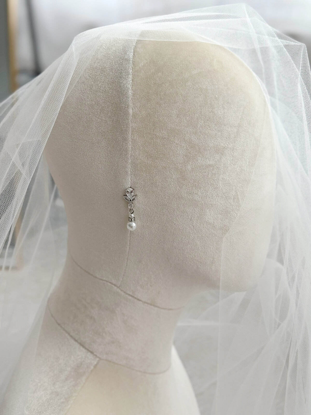 Timeless pearl and crystal earrings adding sparkle to bridal look
