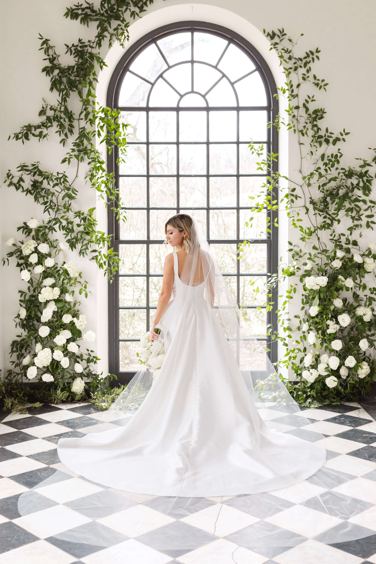 bride in front of large oval window at conestoga house and gardens wedding
