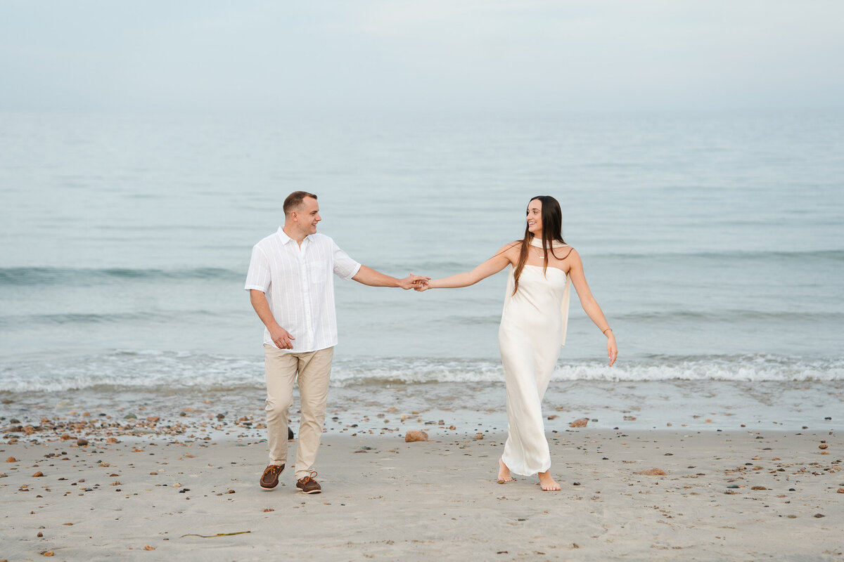 Candid ocean engagement portraits in New England with relaxed emotional storytelling