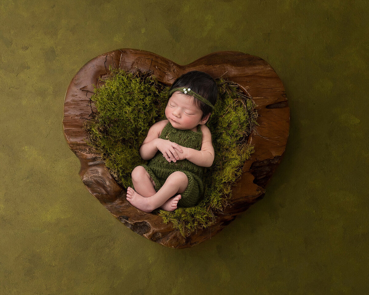 Newborn in Green Heart-shaped Bucket