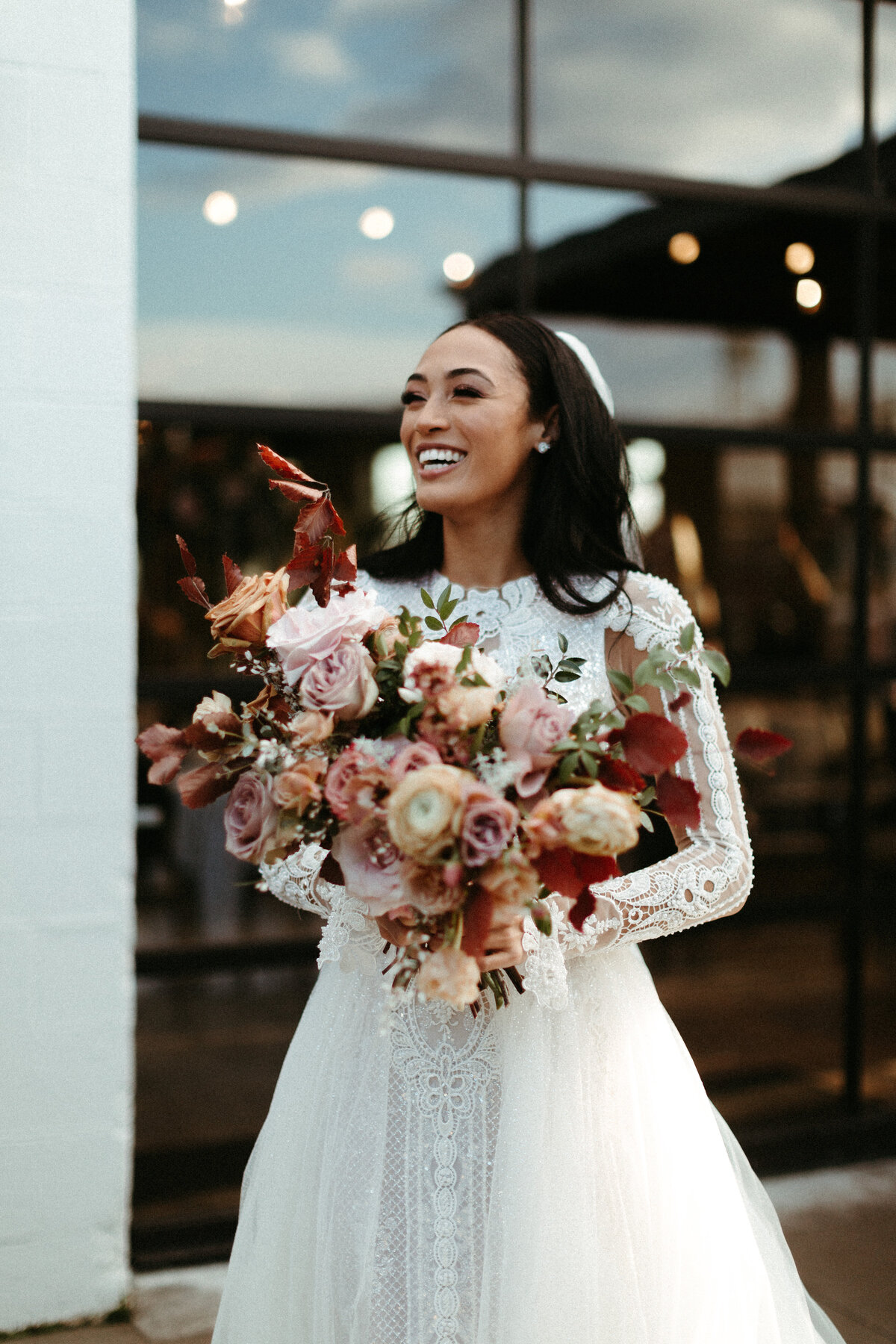 This elegant bridal bouquet brought hues of mauve, dusty pink, cream, burgundy, and terra cotta to this winter wedding. Lush with petal heavy roses, ranunculus, spray roses, copper beech, and greenery. Designed by Rosemary and Finch in Nashville, TN.