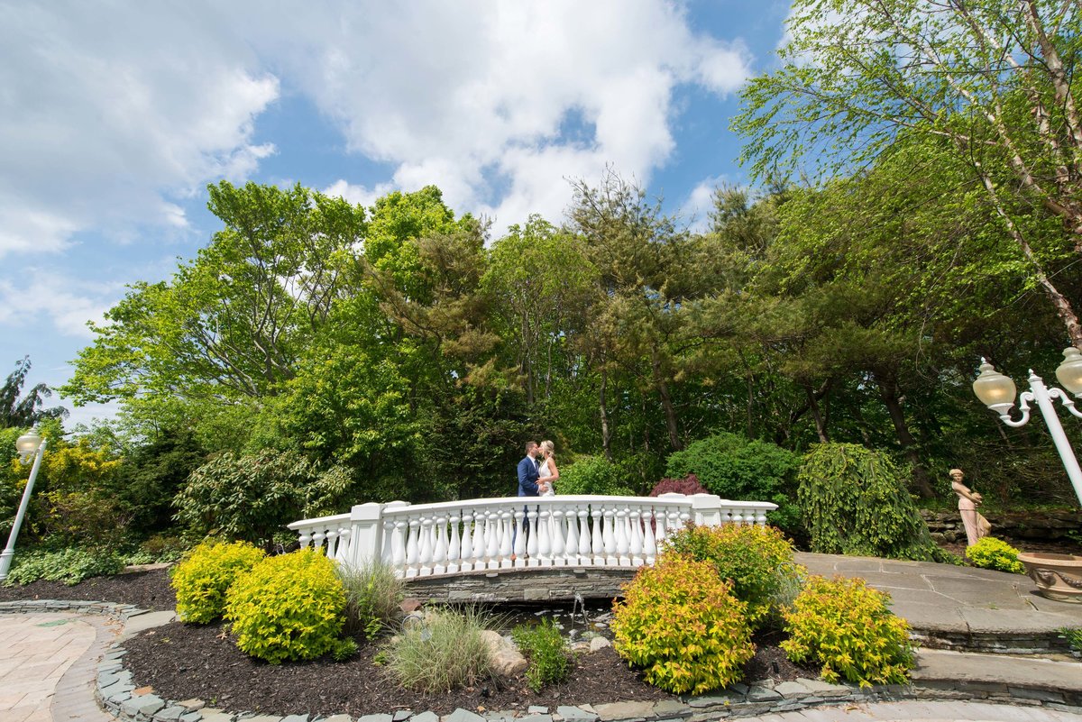 Bride and groom at the bridge of Giorgio's Baiting Hollow