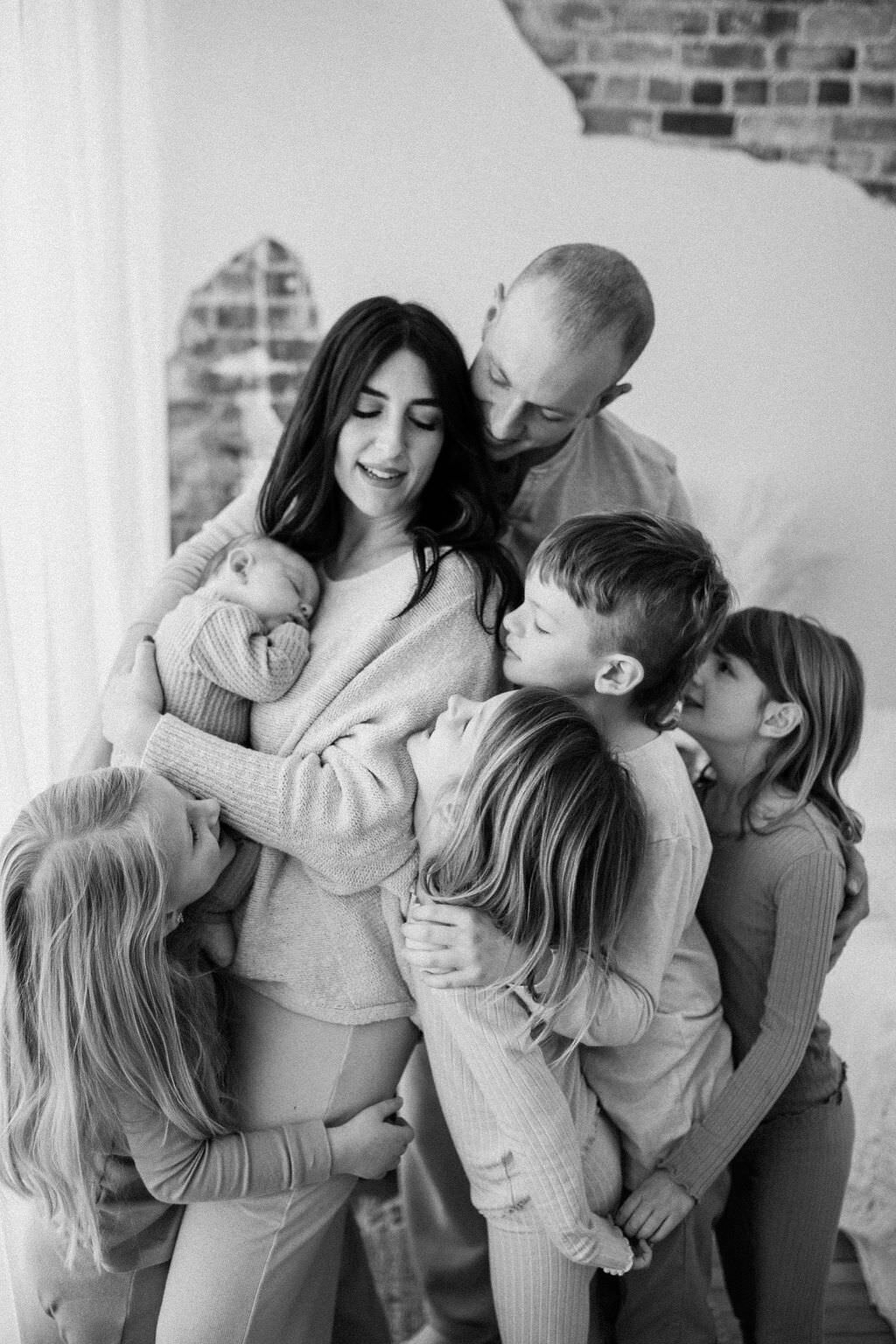 black and white image family embracing mother