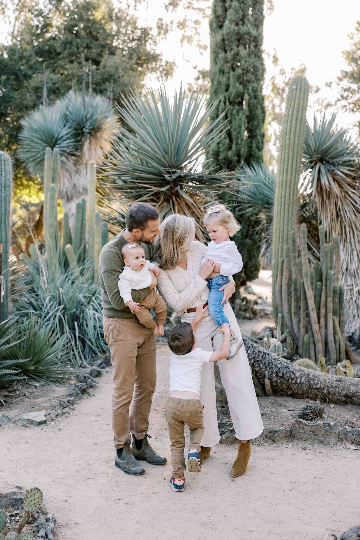 family of 5 standing and tickling each other at arizona cactus garden