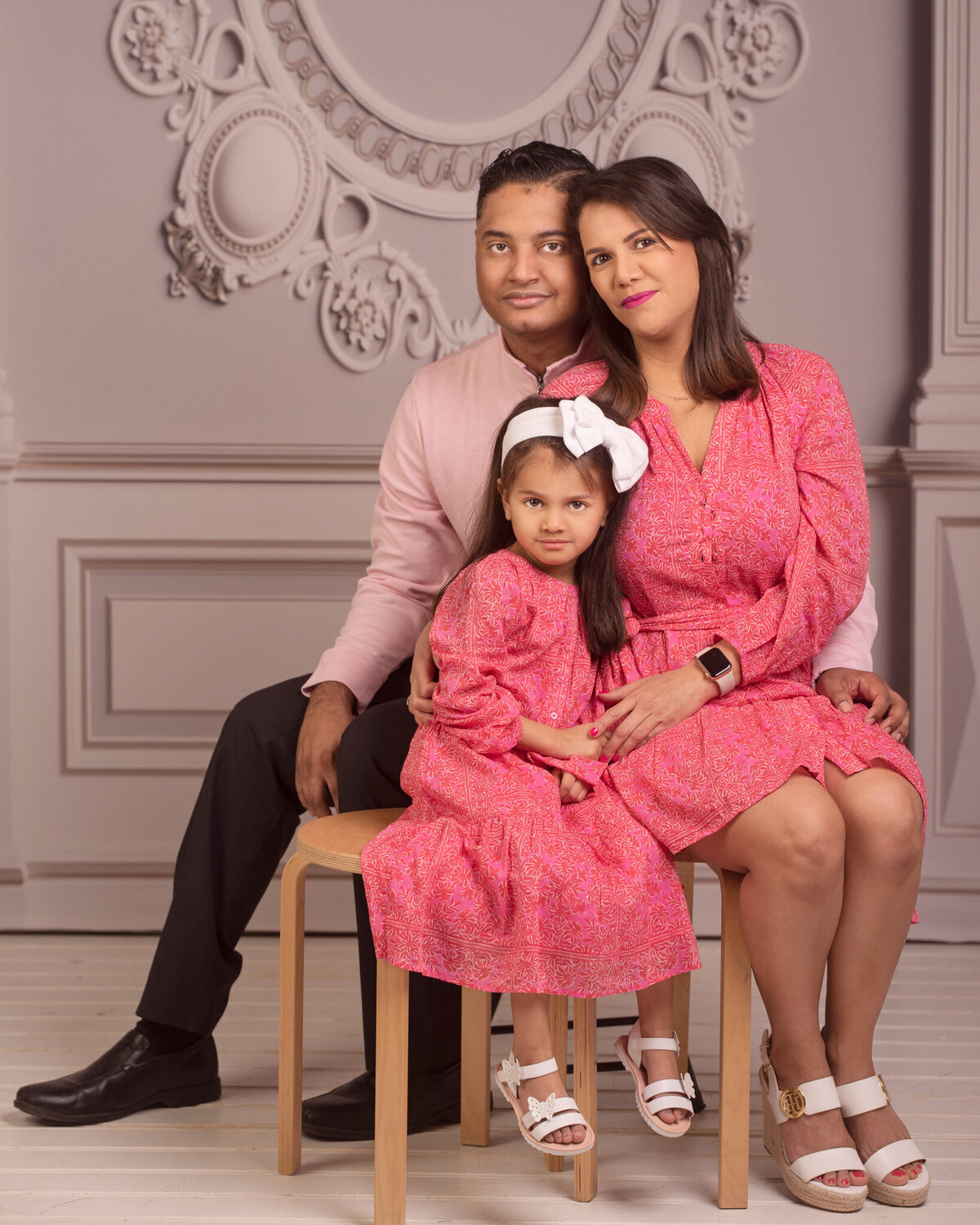 Sophisticated studio portrait of a mother and daughter dressed in pink outfits, captured in Overland Park, Kansas. A timeless option for families looking for refined and elegant family photography in the Kansas City metro area