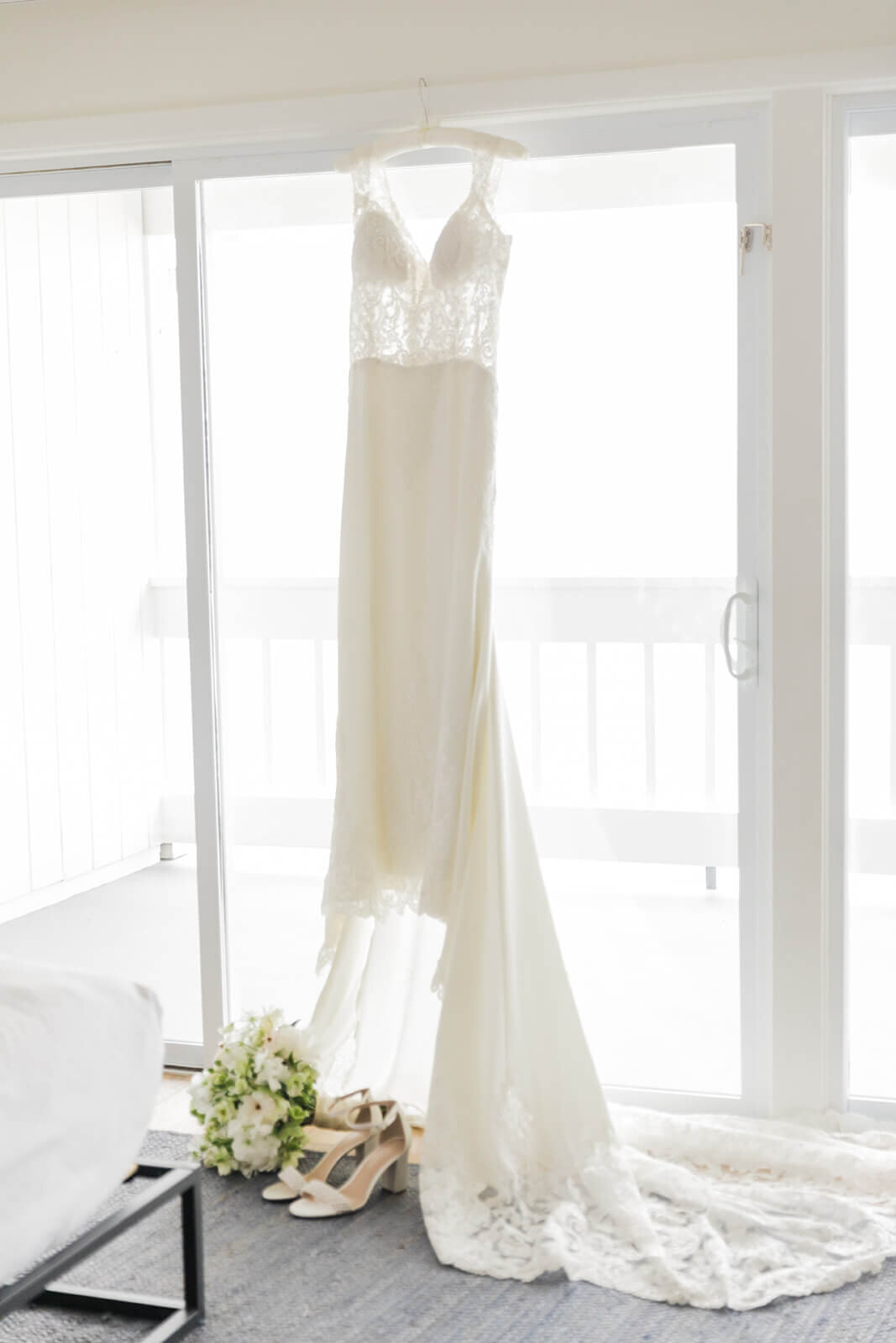 wedding dress hanging from a window