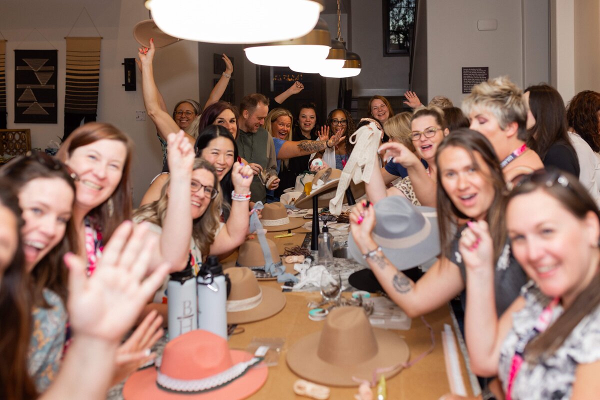 Large group of women being silly while doing crafts