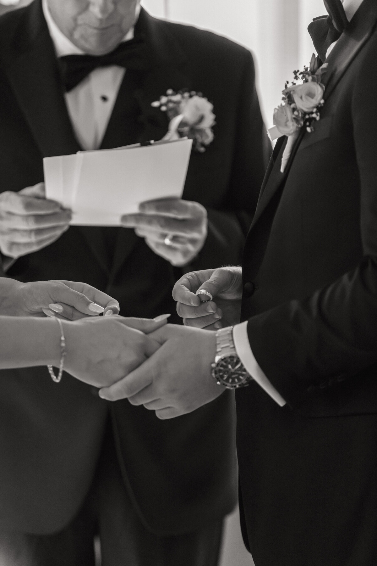 Close-up of wedding ring exchange during ceremony by Philadelphia wedding photographer.