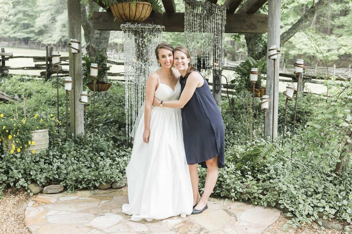 Photographer hugging bride