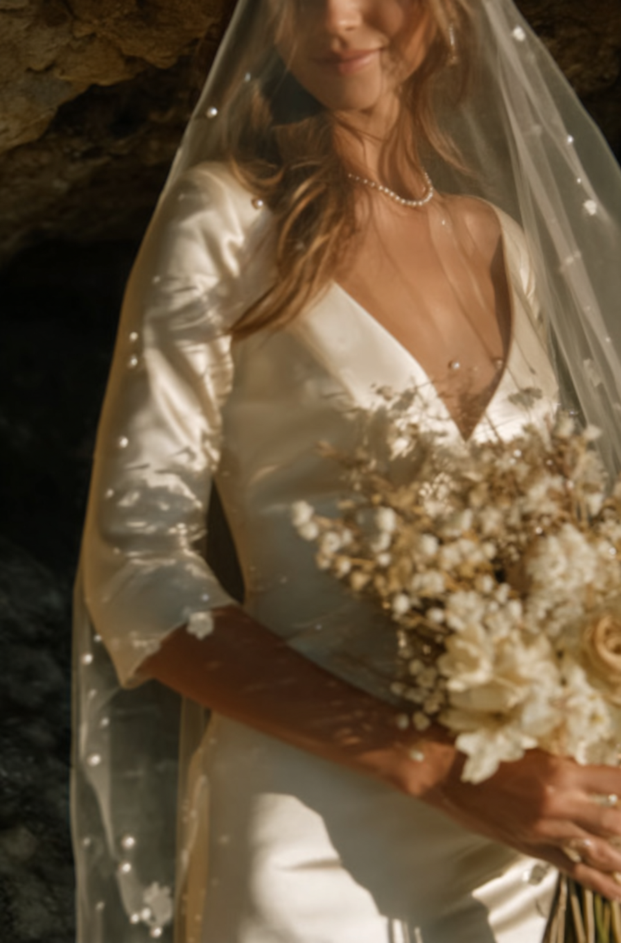 u8487914977_a_close-up_of_a_hand_and_arm_holding_flowers_the__1b298139-564d-4604-a1d1-6b0dd35eea88_2