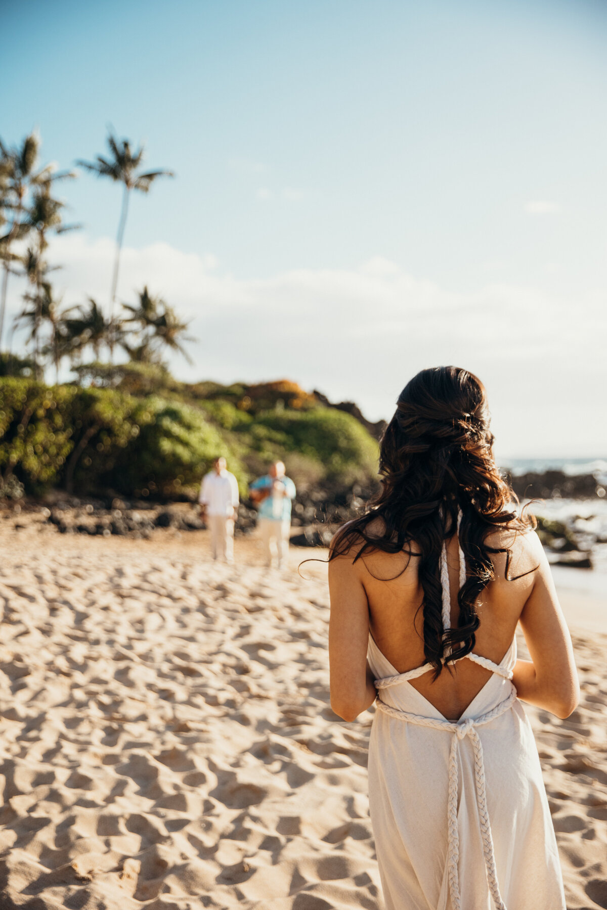 Maui Wedding Photographer captures bride walking down beach to intimate wedding ceremony