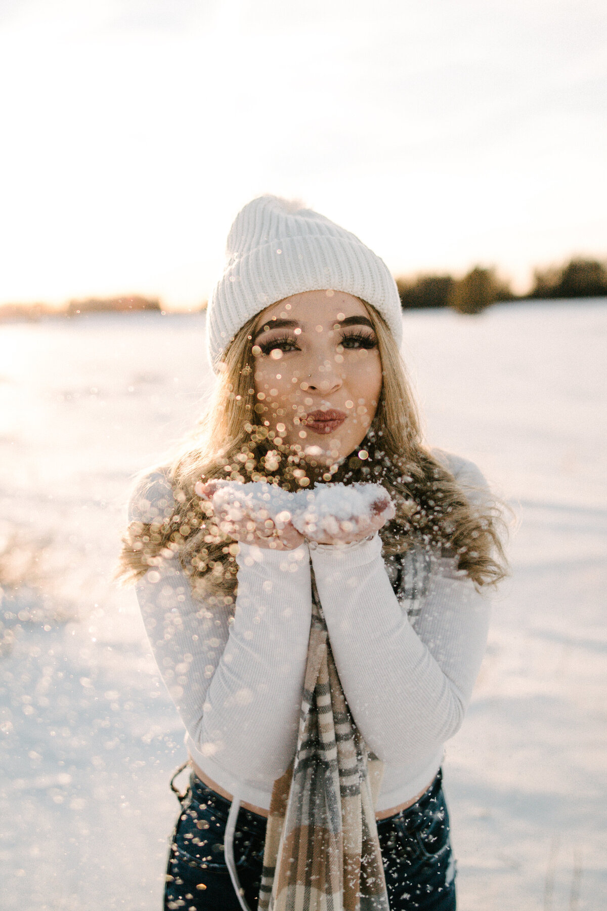 Diana playfully blows snow for her Telluride senior pictures.