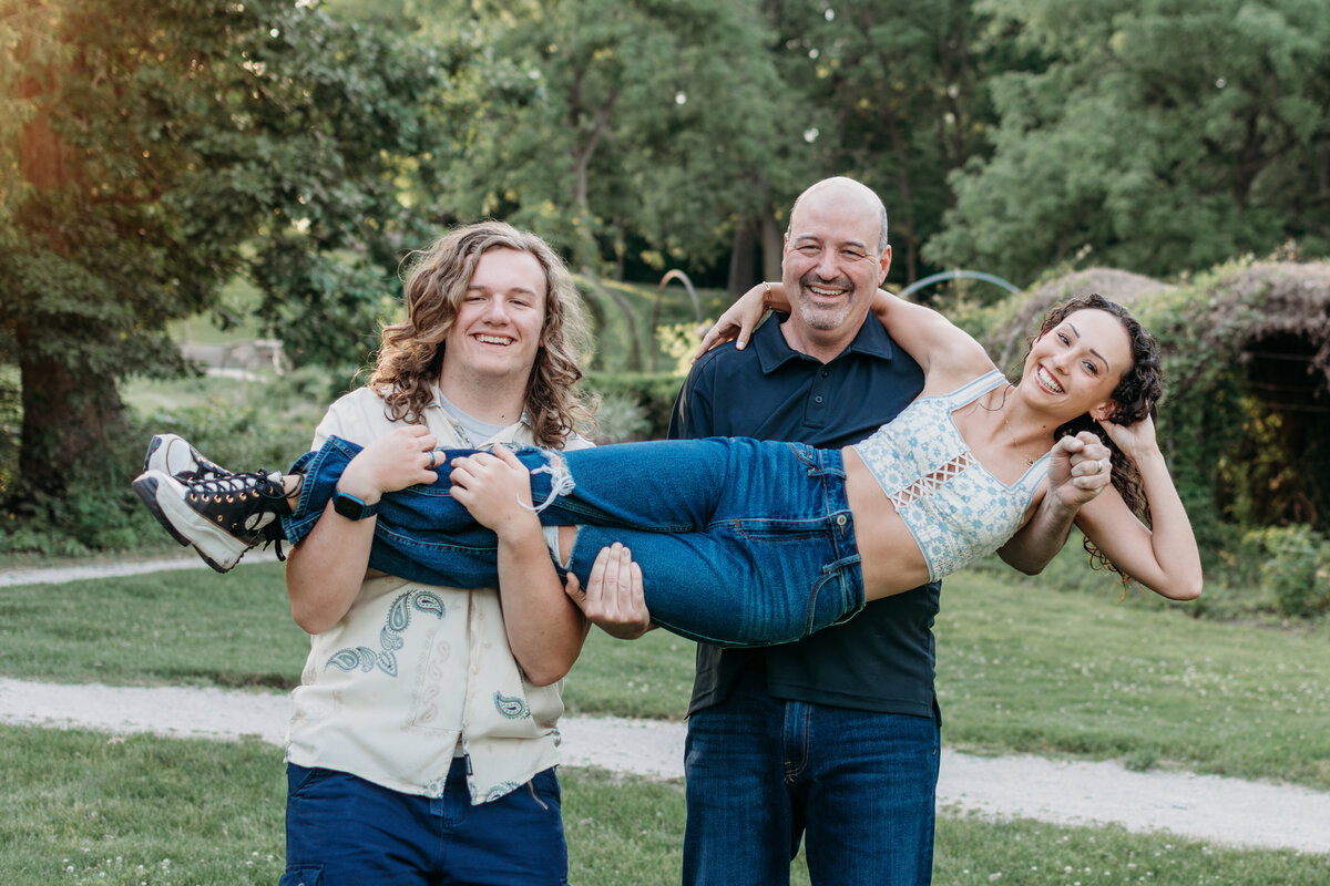 Dad and son holding up the daughter during a fun family photoshoot in Batavia, Il