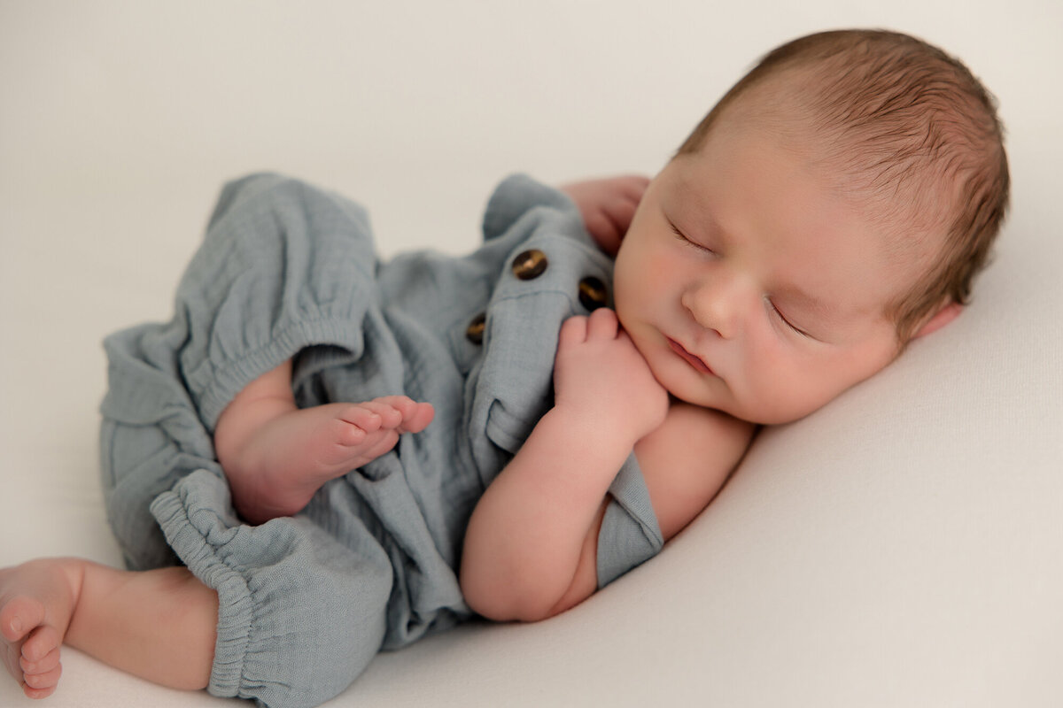 newborn bou in blue overall outfit
