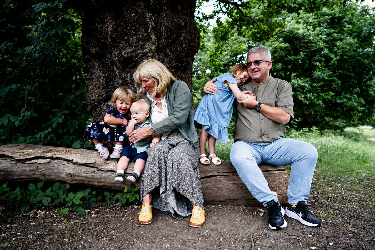 grandchildren crying with grandma whihc third child and grandad hug