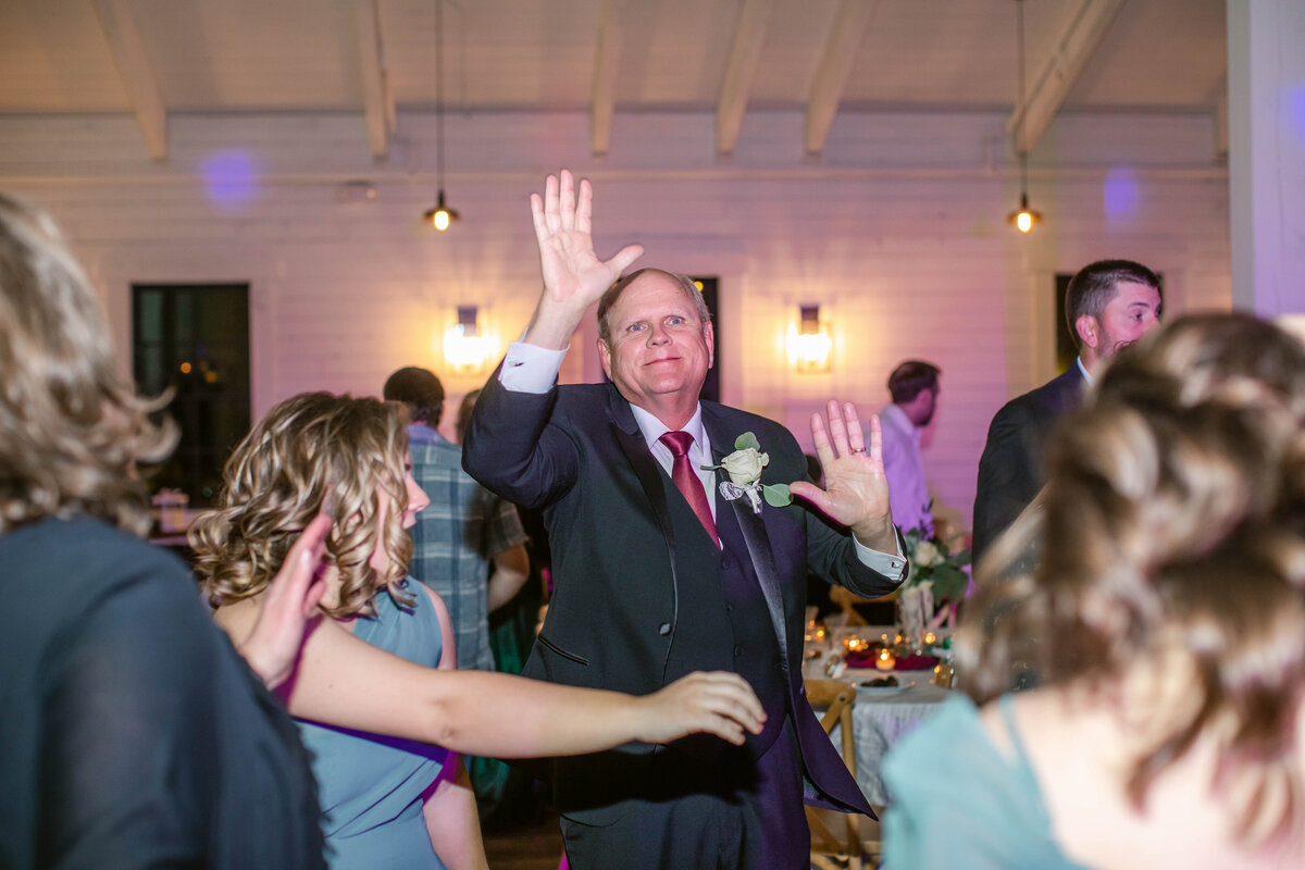 Fort Worth wedding photographer captures father of the bride cheering and dancing