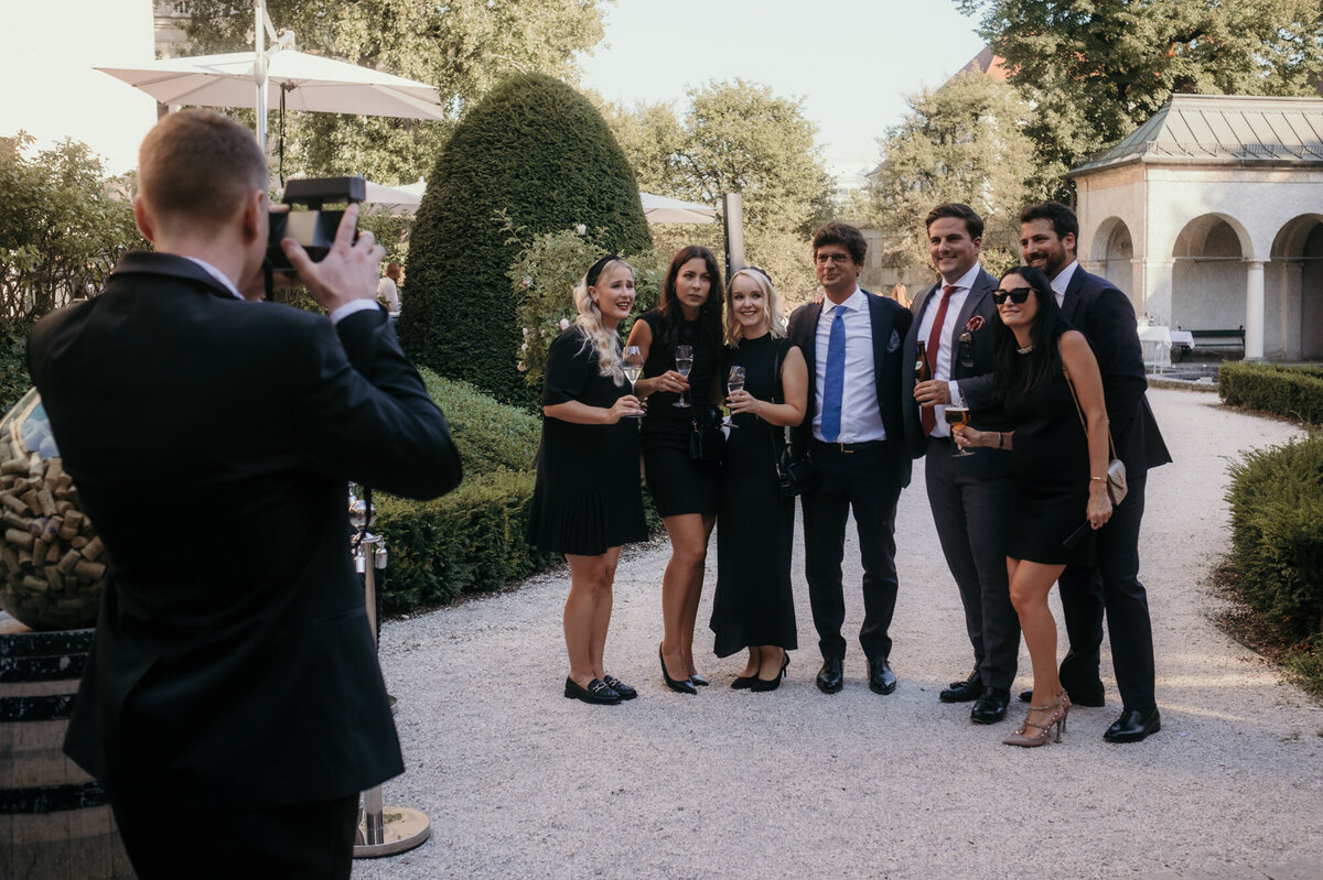 Group picture being made by another guest, captured by the candid wedding photographer.