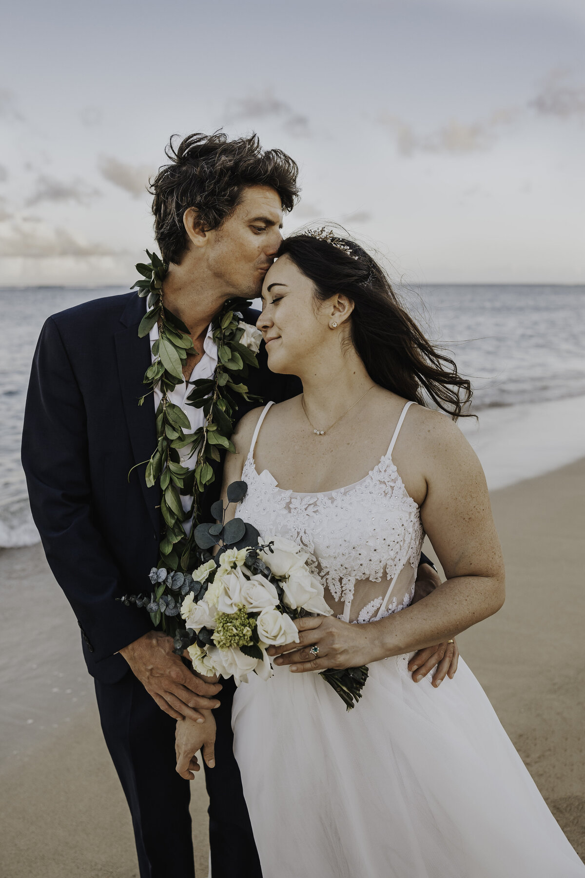 groom kissing brides  forehead