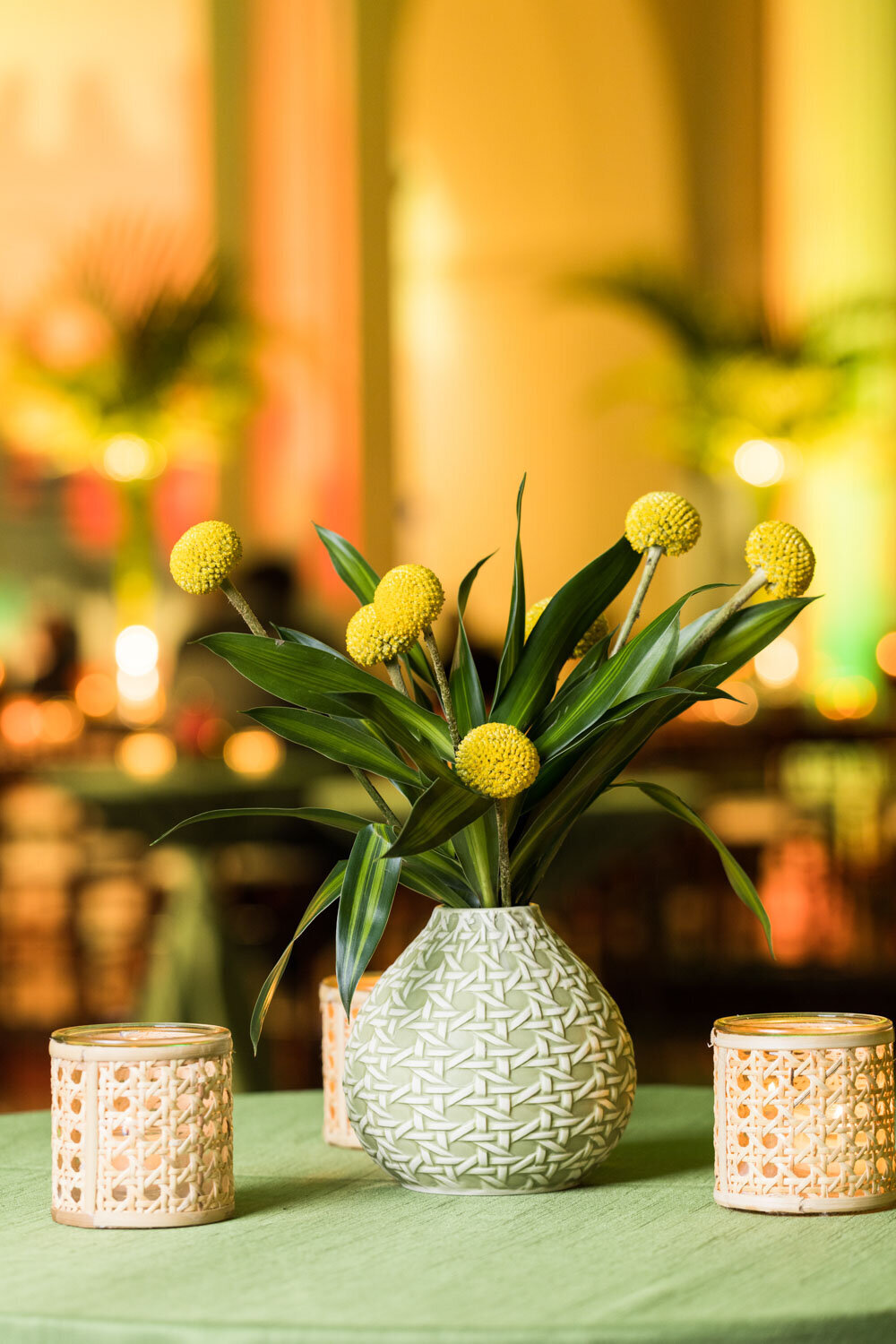 Yellow billy button flowers in patterned vase
