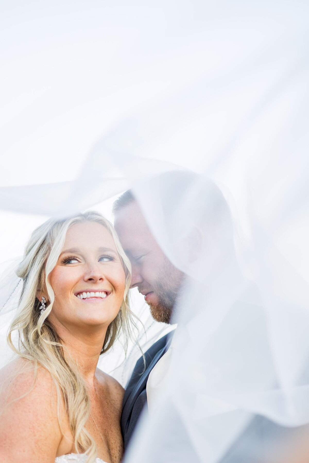 bride and groom under viel New England wedding photographer