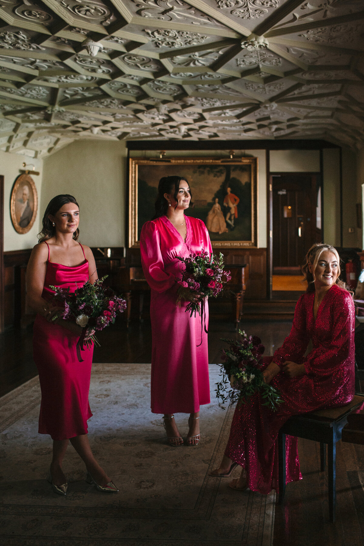 Bridemaids in mismatched hot pink dresses