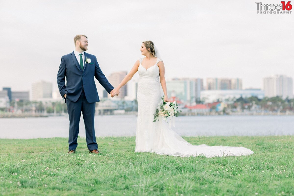 Bride and Groom stare at each other while holding hands during photo session
