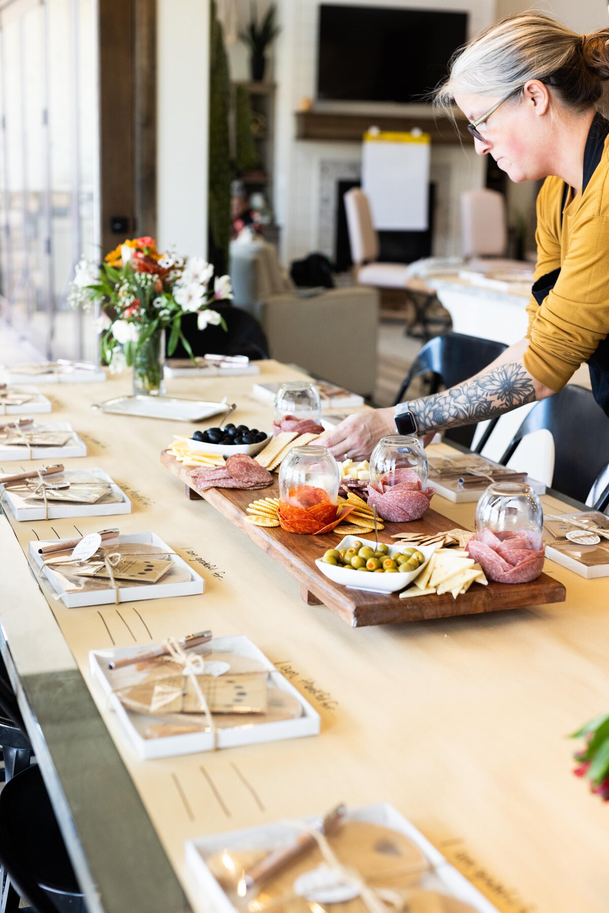 woman setting up a charcuterie board