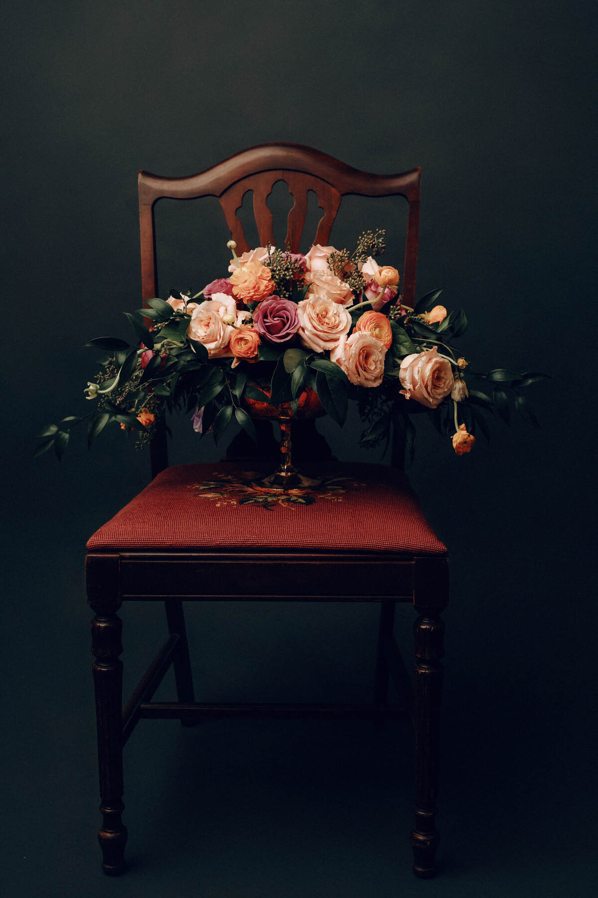 Vase of flowers on an antique chair. Houston, TX.